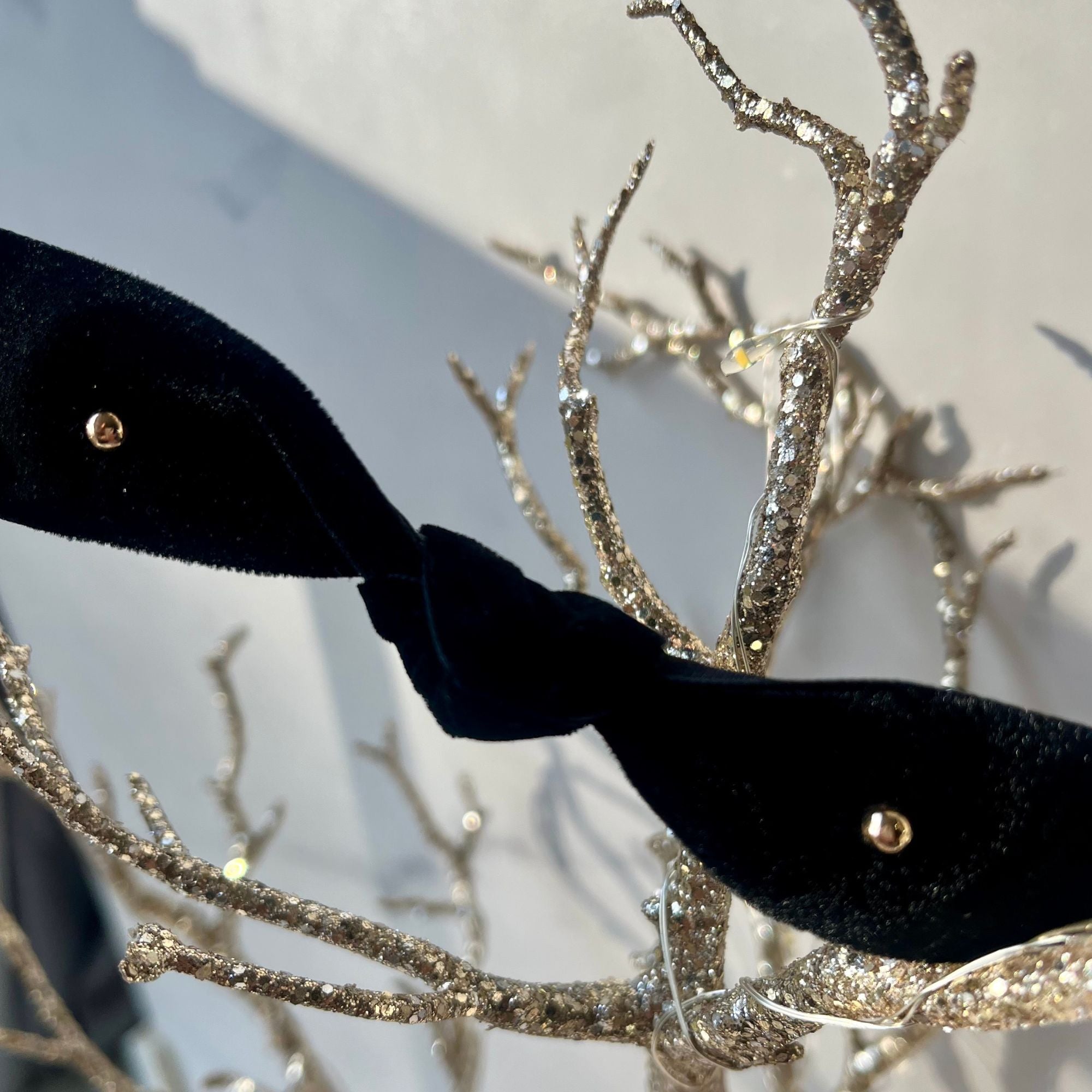 Pair of 14kt solid gold pebble stud earrings with butterfly backs on white fabric background