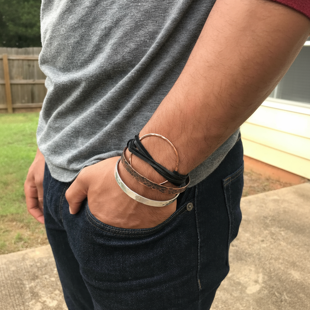 Person wearing multiple bracelets on a wrist with a casual background by The Pink Locket